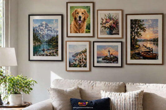 Collection of framed paint by numbers artworks displayed on a modern Canadian living room wall showing landscapes, animals, and custom portraits with natural lighting