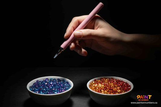 Two bowls of diamond painting drills (blue and gold) with a pink applicator pen poised above by Paint On Numbers.