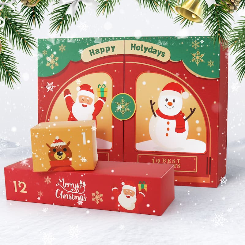 Red and green Christmas-themed art gift box featuring Santa and a snowman with “Happy Holydays” text, surrounded by snow and pine branches, with two smaller numbered gift drawers displayed in front showing festive designs.