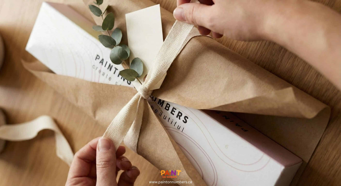 Paint by numbers kit wrapped in brown paper with ribbon, prepared as a thoughtful handmade gift