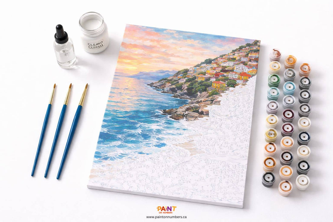 A top-down view of a highly organized paint by numbers workstation featuring a detailed canvas, clean brushes, a water dropper, and clear gesso.