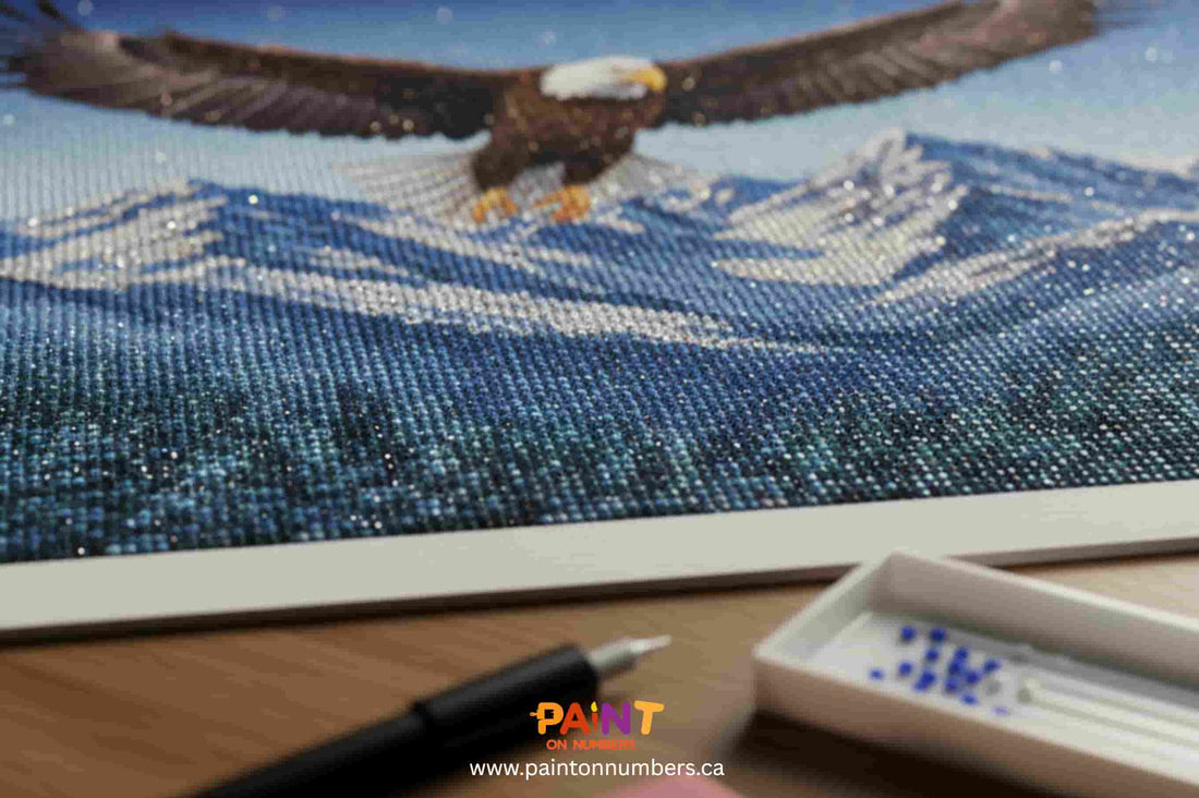 Close-up of an eagle diamond painting canvas with drills and applicator — diamond painting kit (Paint On Numbers, Canada).