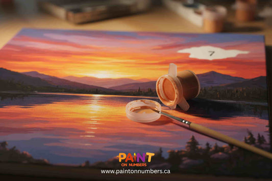 Paint by numbers sunset canvas with one unpainted section. Empty paint pot and brush emphasize creative struggle.