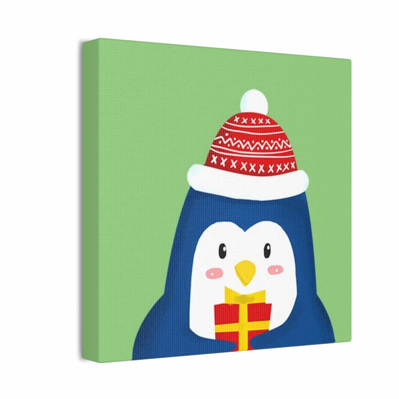 Canvas print of a penguin wearing a Christmas hat on a green background