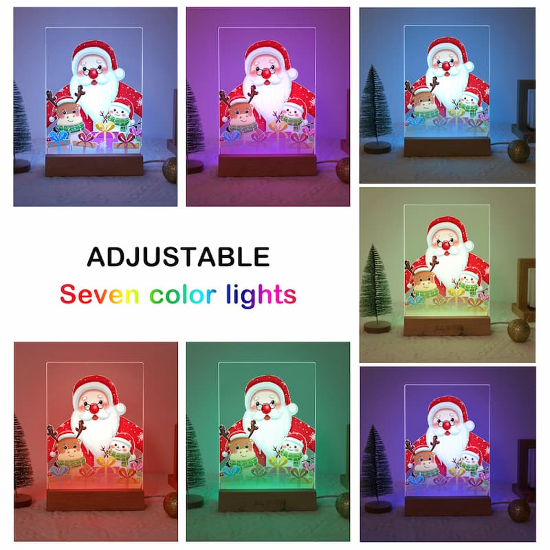 A collage showing a tabletop Christmas light with a Santa Claus illustration, displayed in eight color modes around the text 'ADJUSTABLE Seven color lights.' The product appears to be a clear acrylic box on a wooden base, with internal LED lighting and multicolor preset options including purple, blue, green, red, and dark tones.