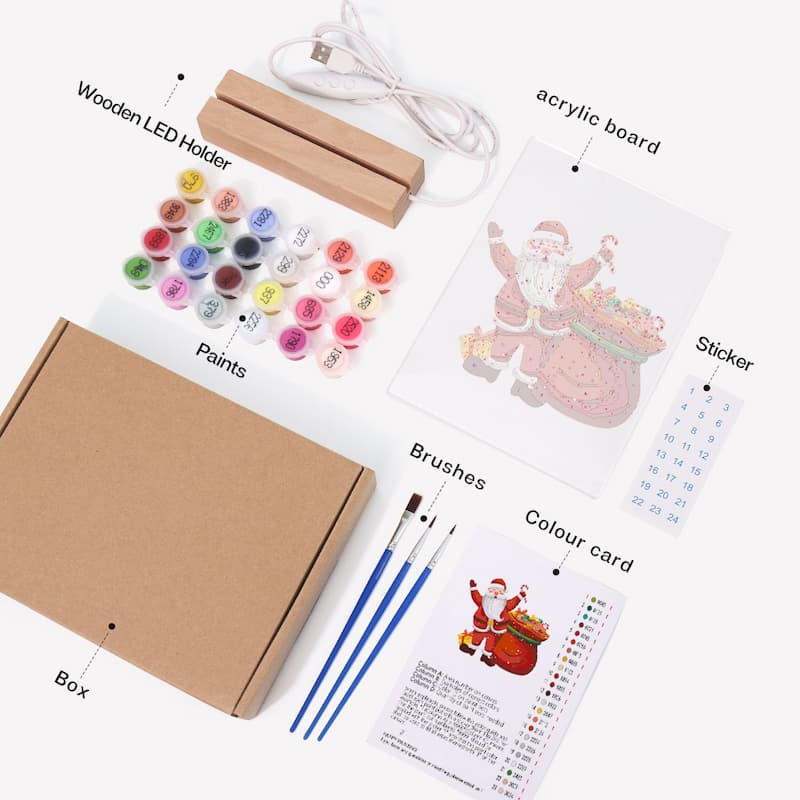 A Christmas-themed acrylic painting kit laid out on a white background, including a kraft paper box, wooden LED light holder, USB charging cable, acrylic board with Santa illustration, sticker, paint pots, brushes, color card, and instruction sheet.