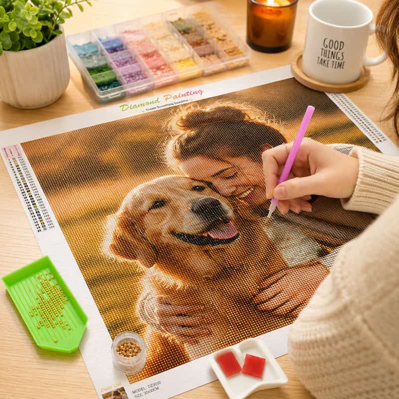 Person working on a diamond painting of a woman and dog with art supplies on a table.