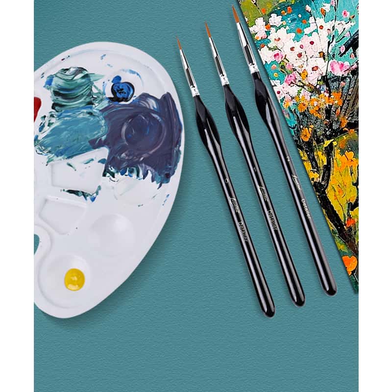 Set of paintbrushes on a teal surface with a paint palette and floral painting in the background.