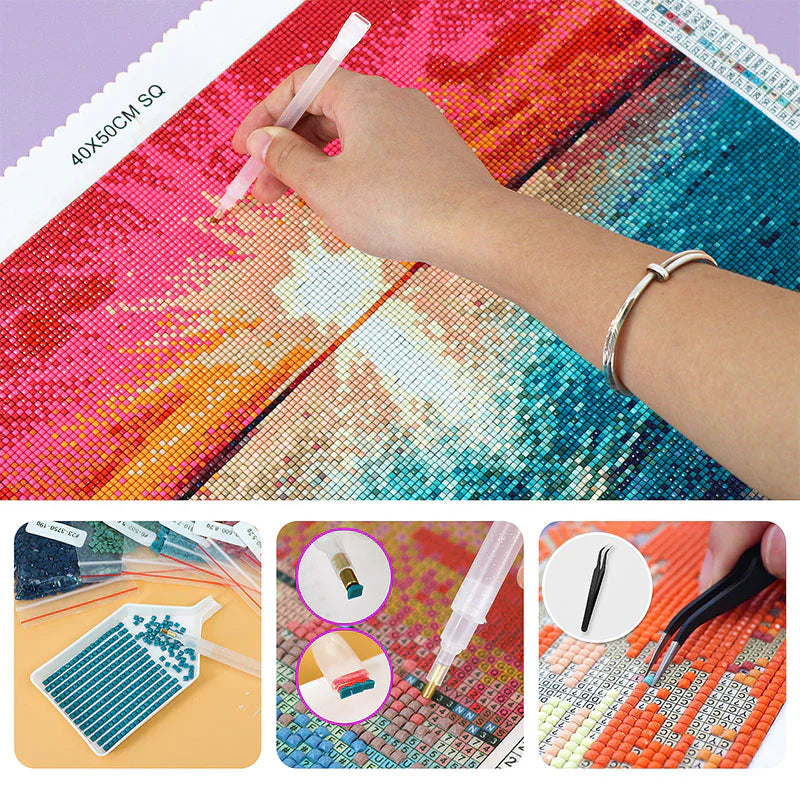 Close-up of a hand placing diamond raisins on a colorful 40x50 cm canvas with diamond painting tools, trays, pens, and tweezers shown in detail.