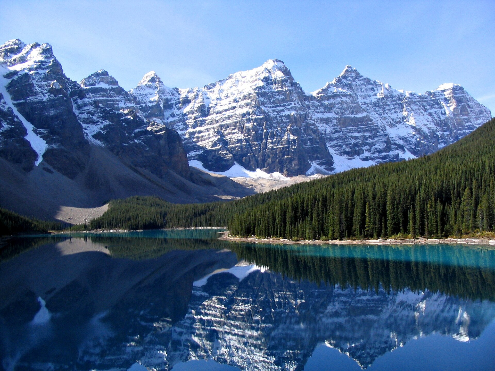 Moraine Lake Paint By Numbers painting featuring crystal-clear turquoise waters, towering snow-covered peaks of the Canadian Rockies, and a dense pine forest reflecting perfectly in the still lake