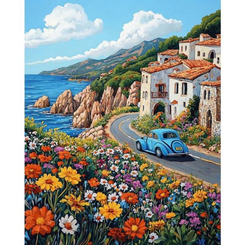 Scenic coastal road with a blue car, colorful flowers, and Mediterranean-style buildings.